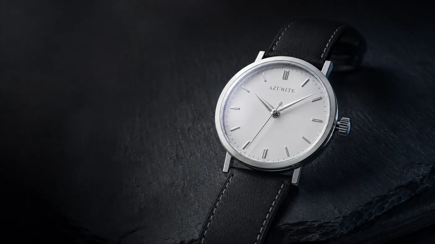 AZURITE Alba lying on a slab of dark slate, the white dial lit from the upper left