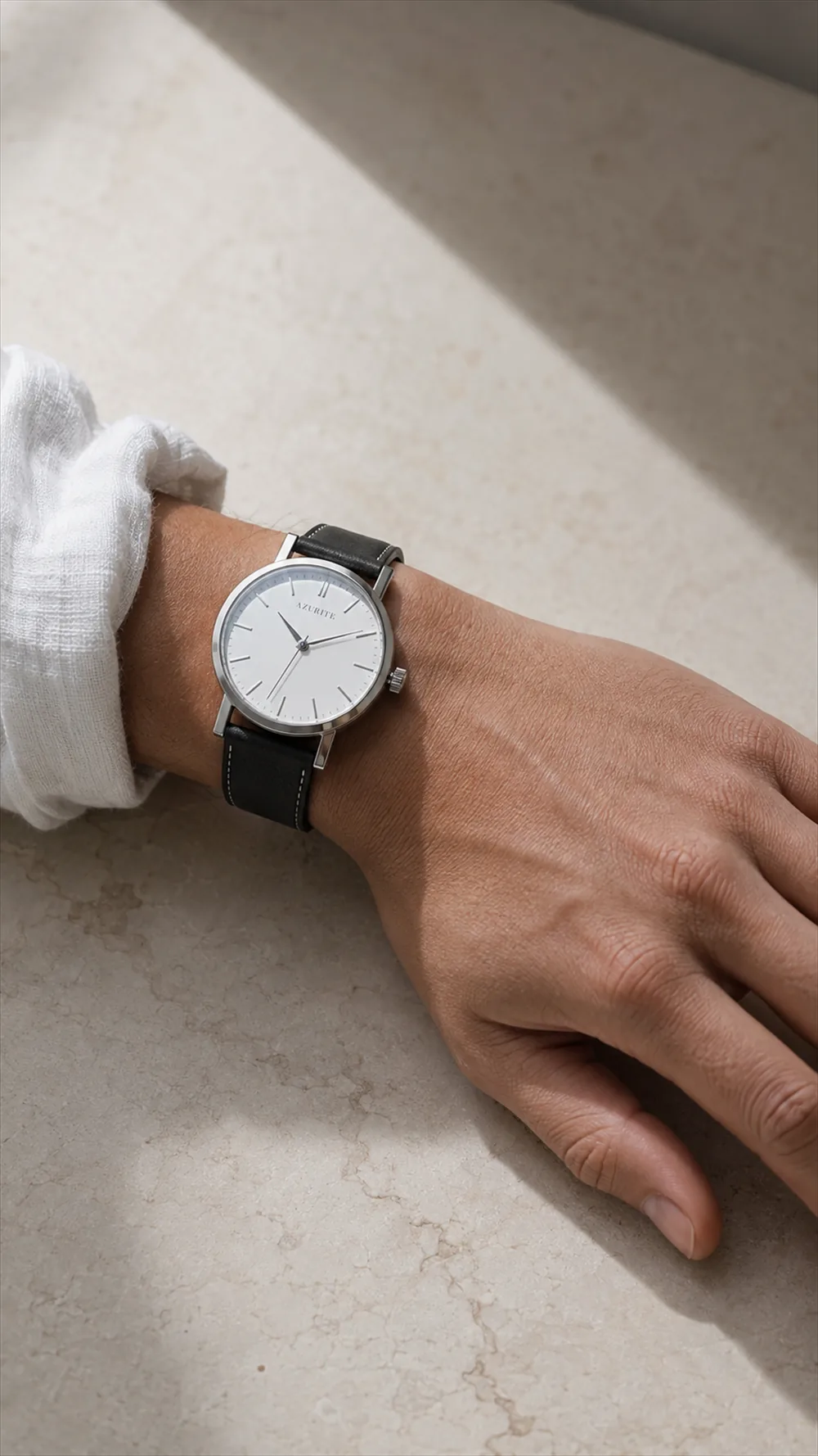 The Alba on a wrist, the cuff of a white linen shirt pushed back
